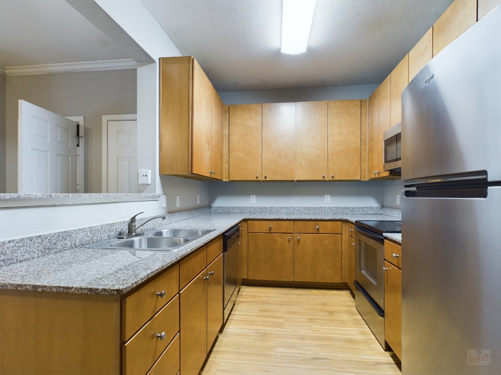 a kitchen with granite countertop a sink and cabinets