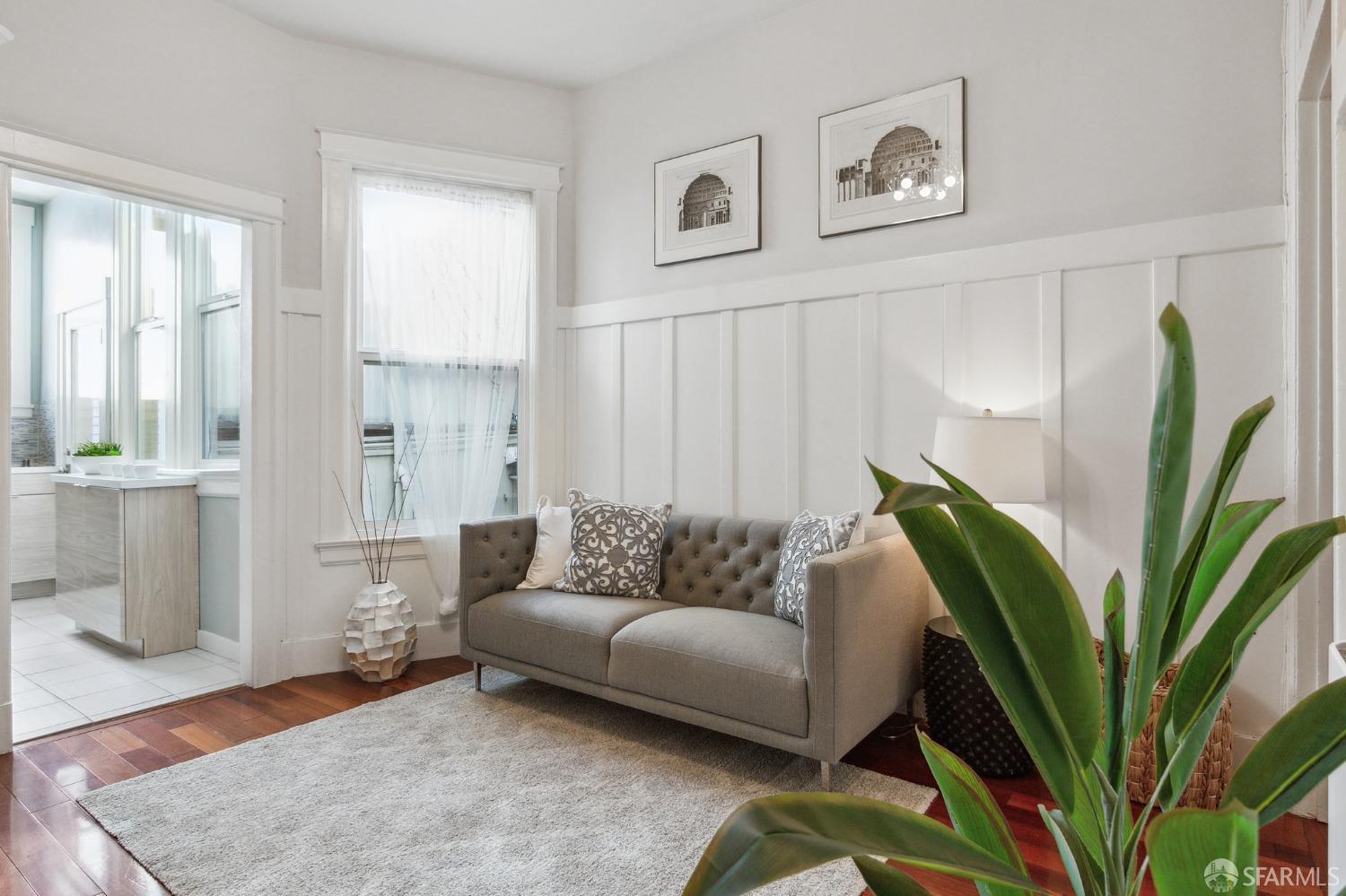 a living room with furniture and a potted plant