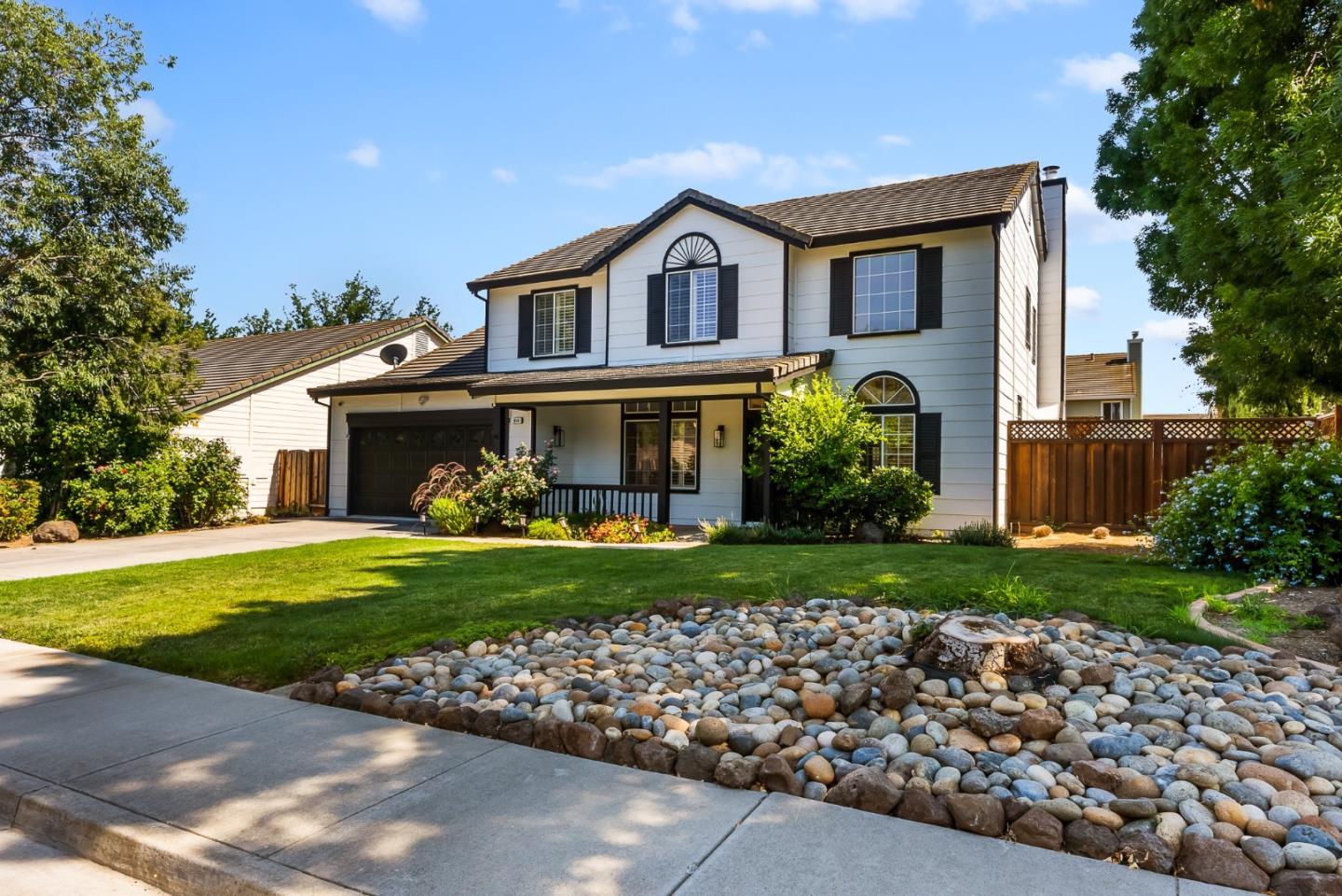 a front view of a house with garden