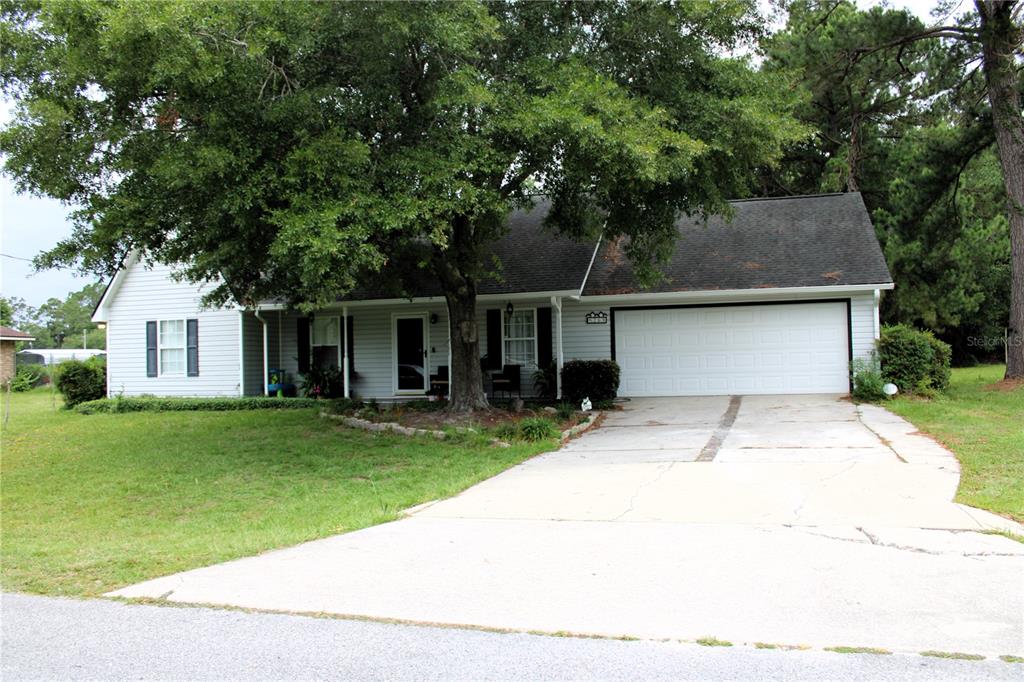 a front view of house with yard and green space