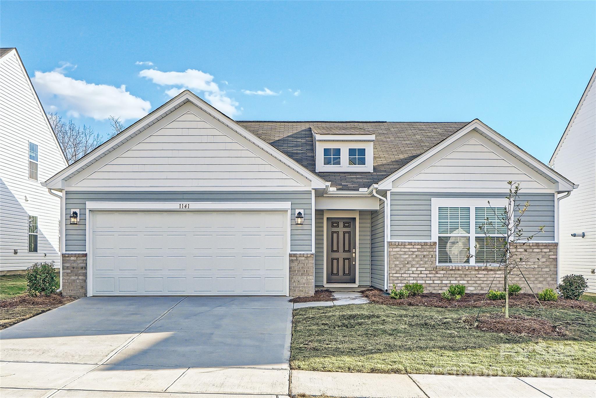 a front view of a house with garage