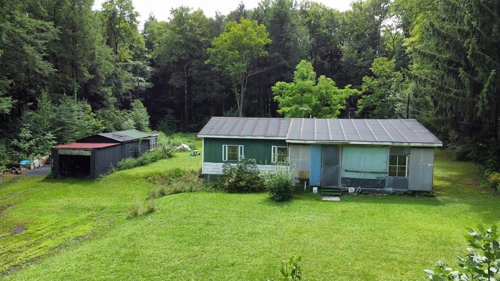 a view of a house with a backyard