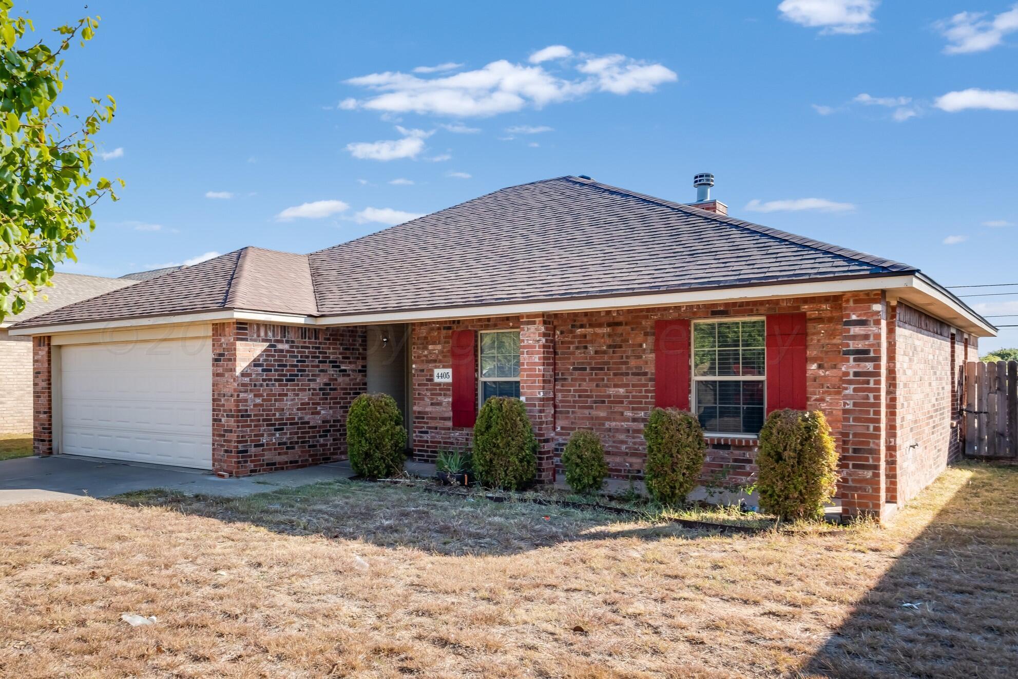 a view of a house with a yard and garage