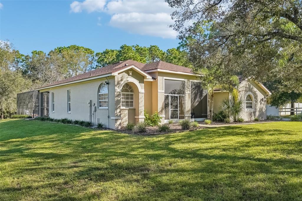 a front view of house with yard and green space