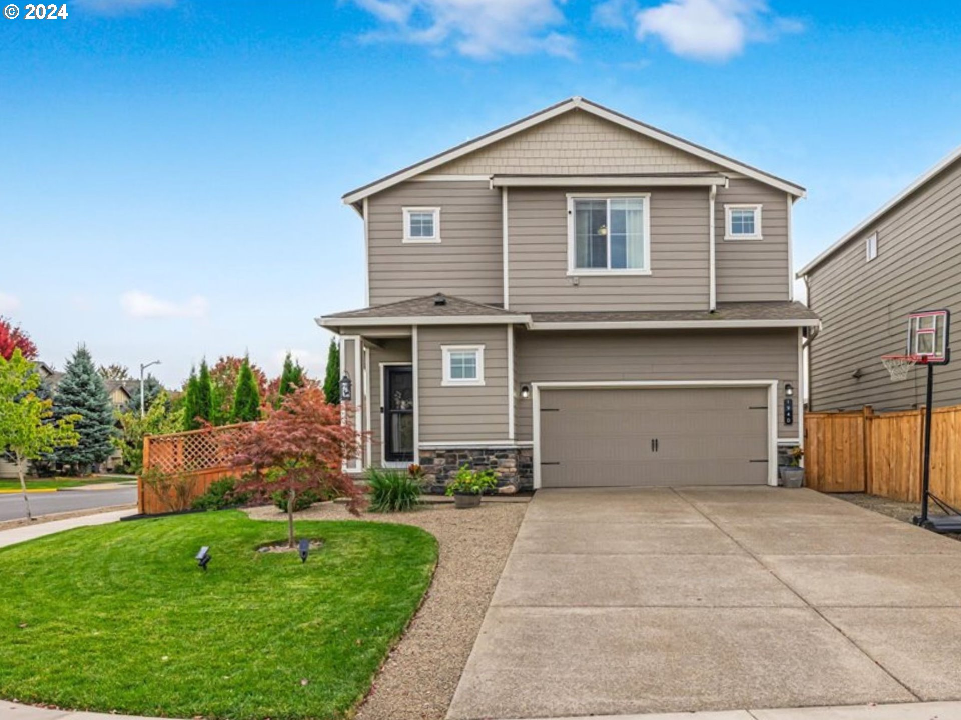 a front view of a house with a yard and garage