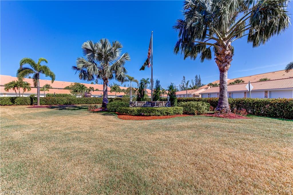 a row of palm trees and a yard in front of a house