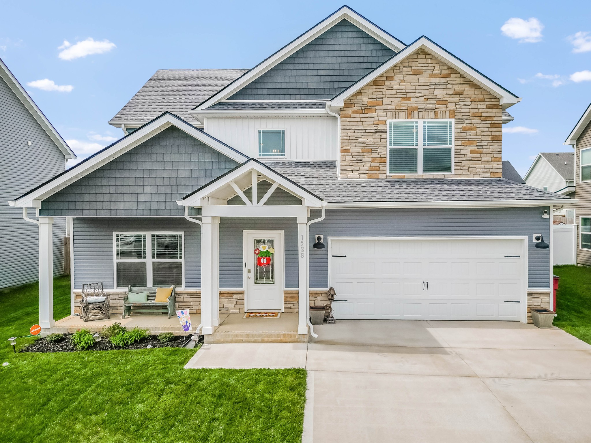 a front view of a house with a yard and garage