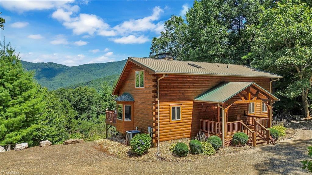 Embrace the charm of rustic living in this cozy 3 level cabin nestled among towering pines and hardwoods offering a serene retreat amidst nature's beauty.