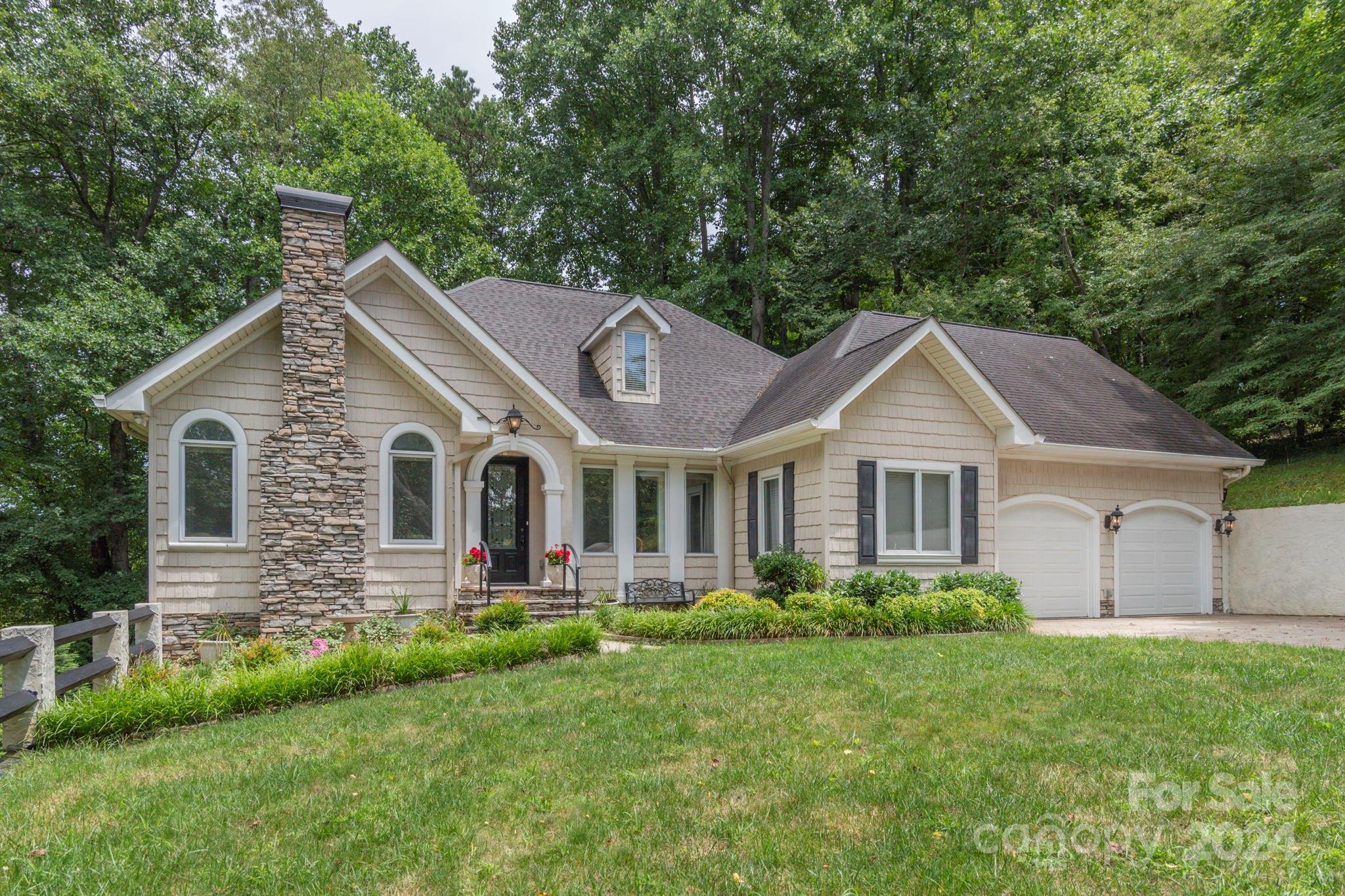 a front view of house with yard and green space