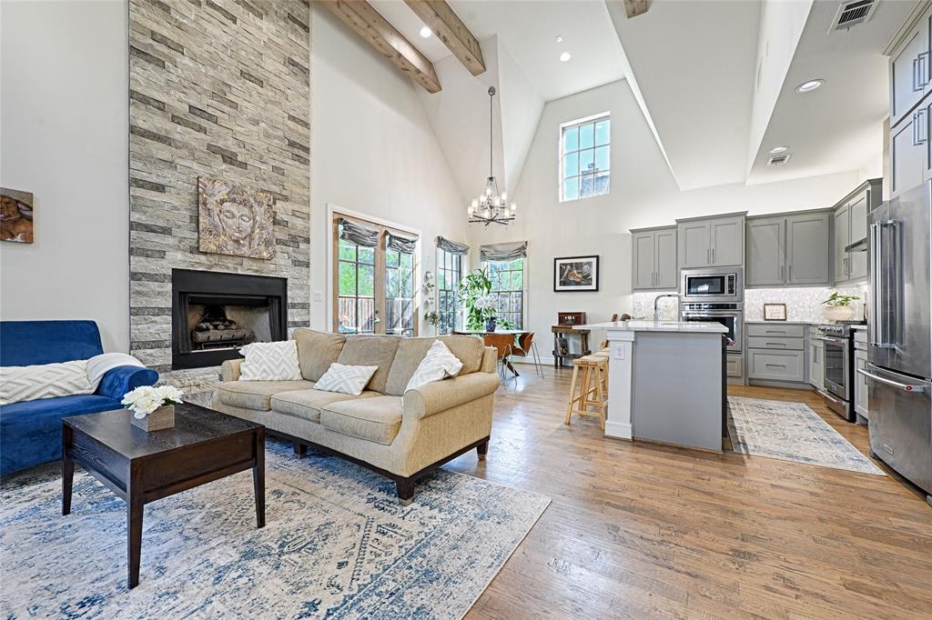 a living room with furniture wooden floor and a fireplace