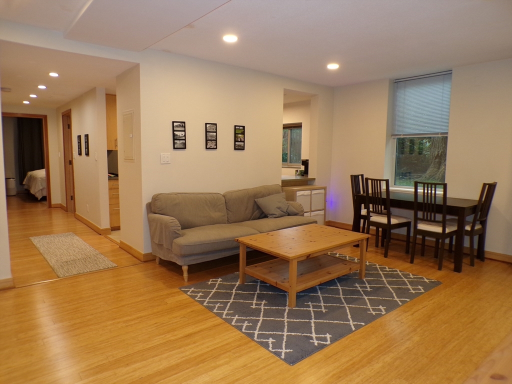 a living room with furniture a pool table and a couch