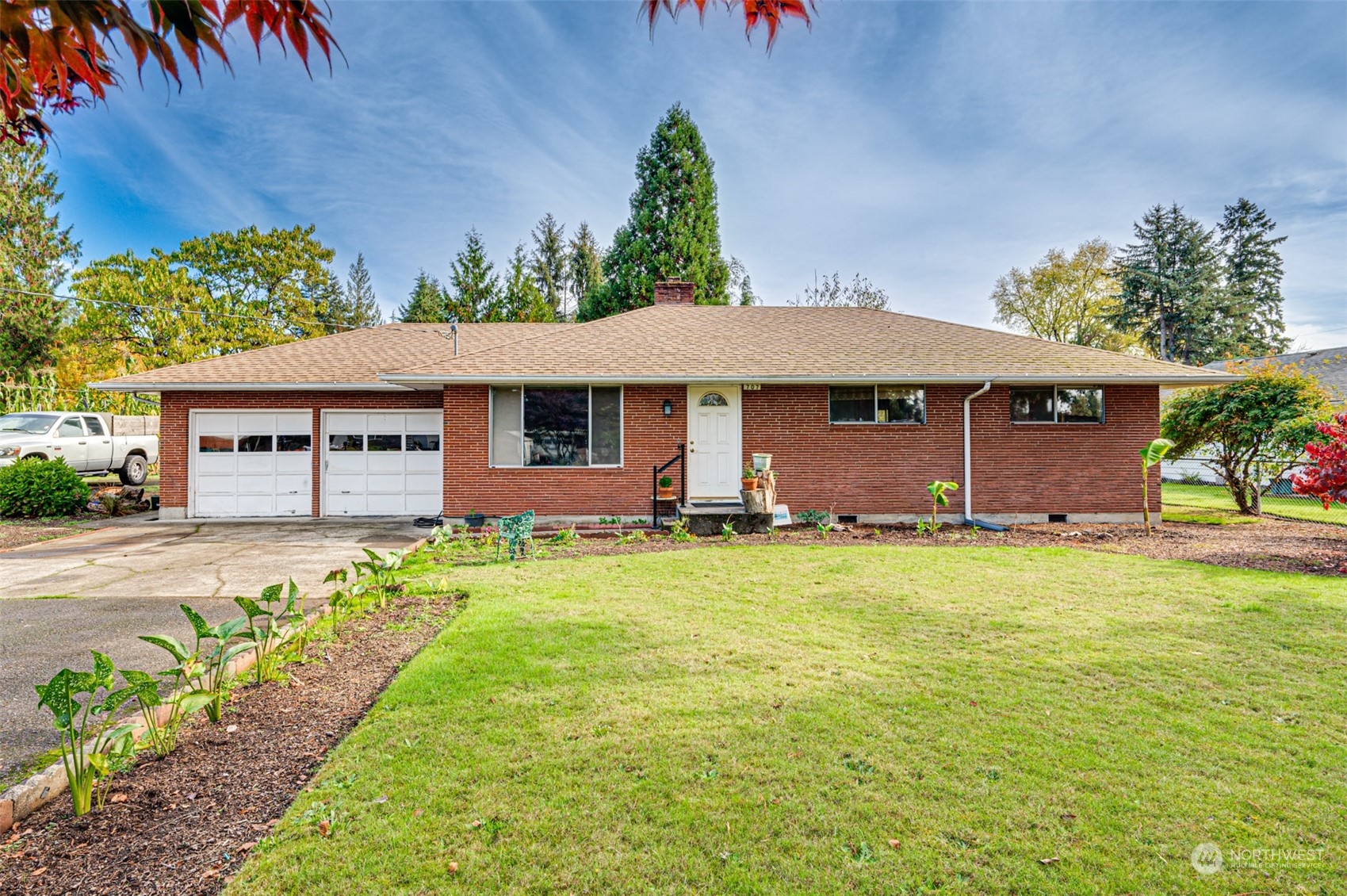 a front view of a house with a garden