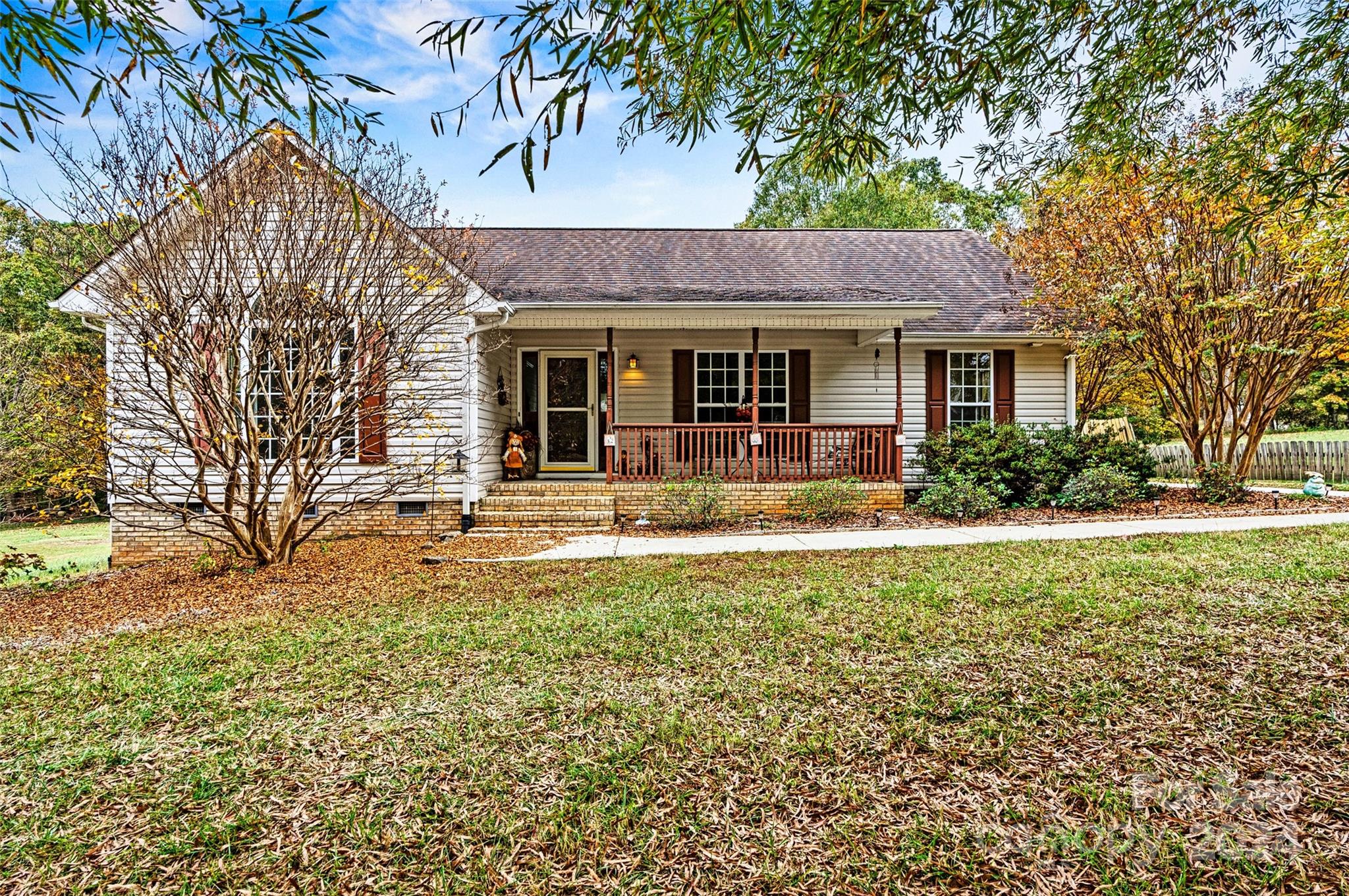 a front view of a house with yard and green space