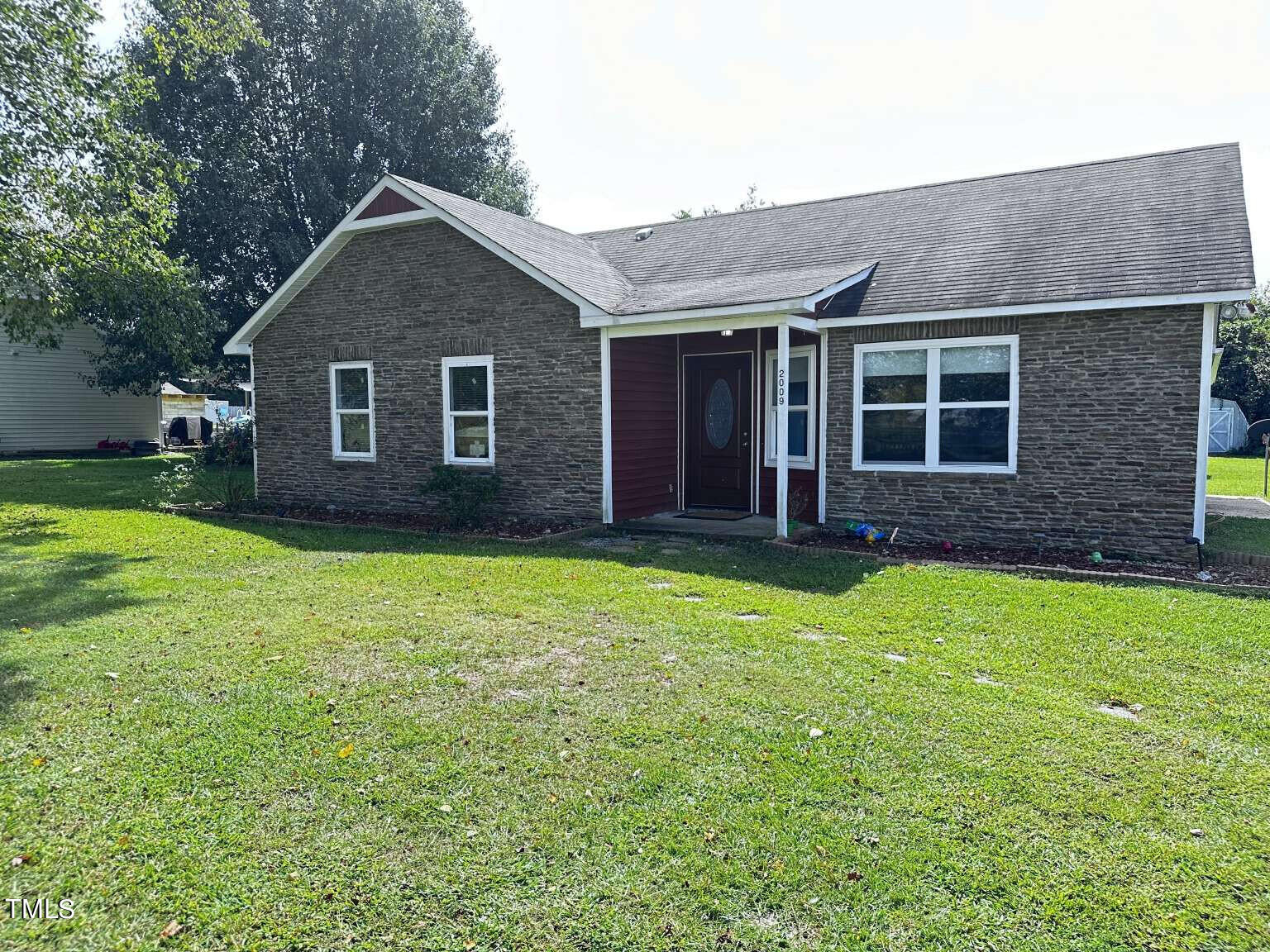 a front view of house with yard and green space