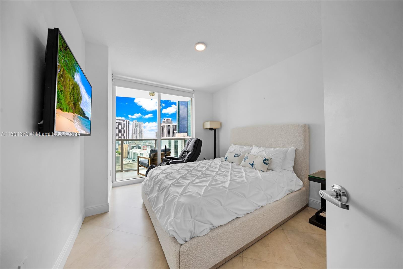 a bedroom with a bed and flat screen tv