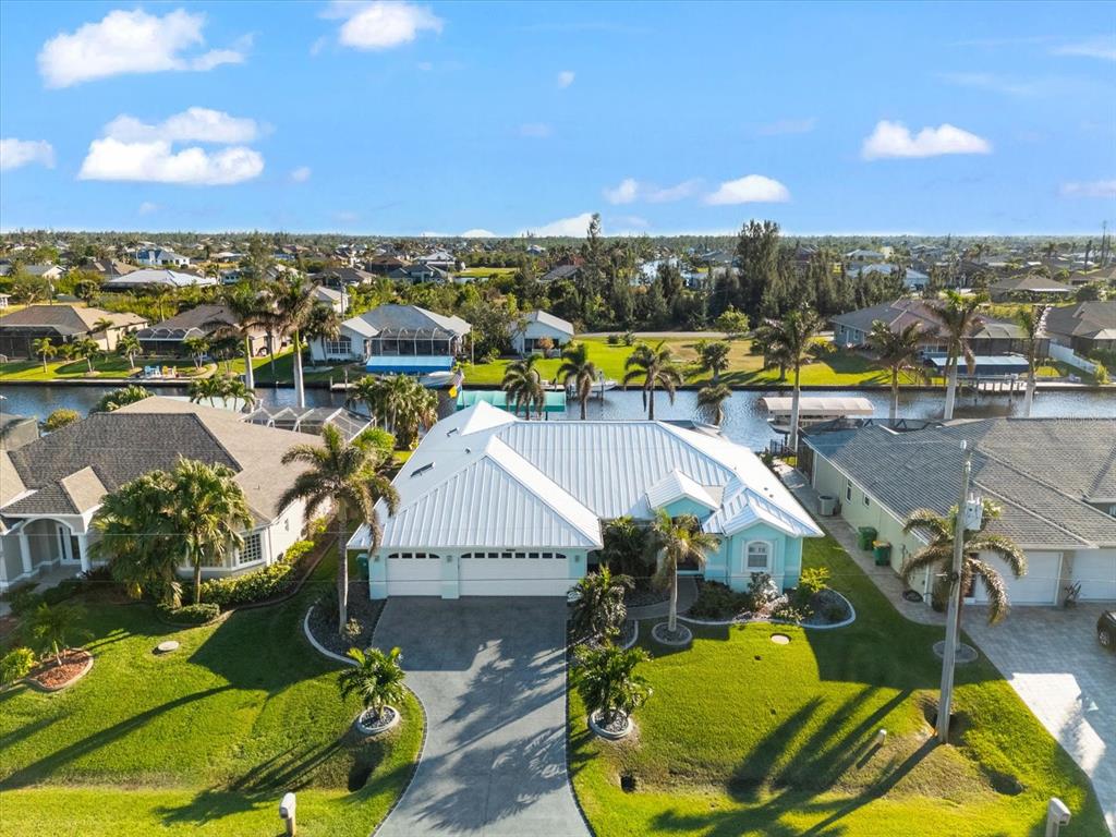 an aerial view of a residential houses with outdoor space and swimming pool