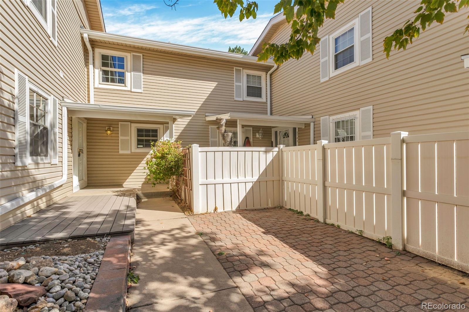 a view of a house with wooden fence