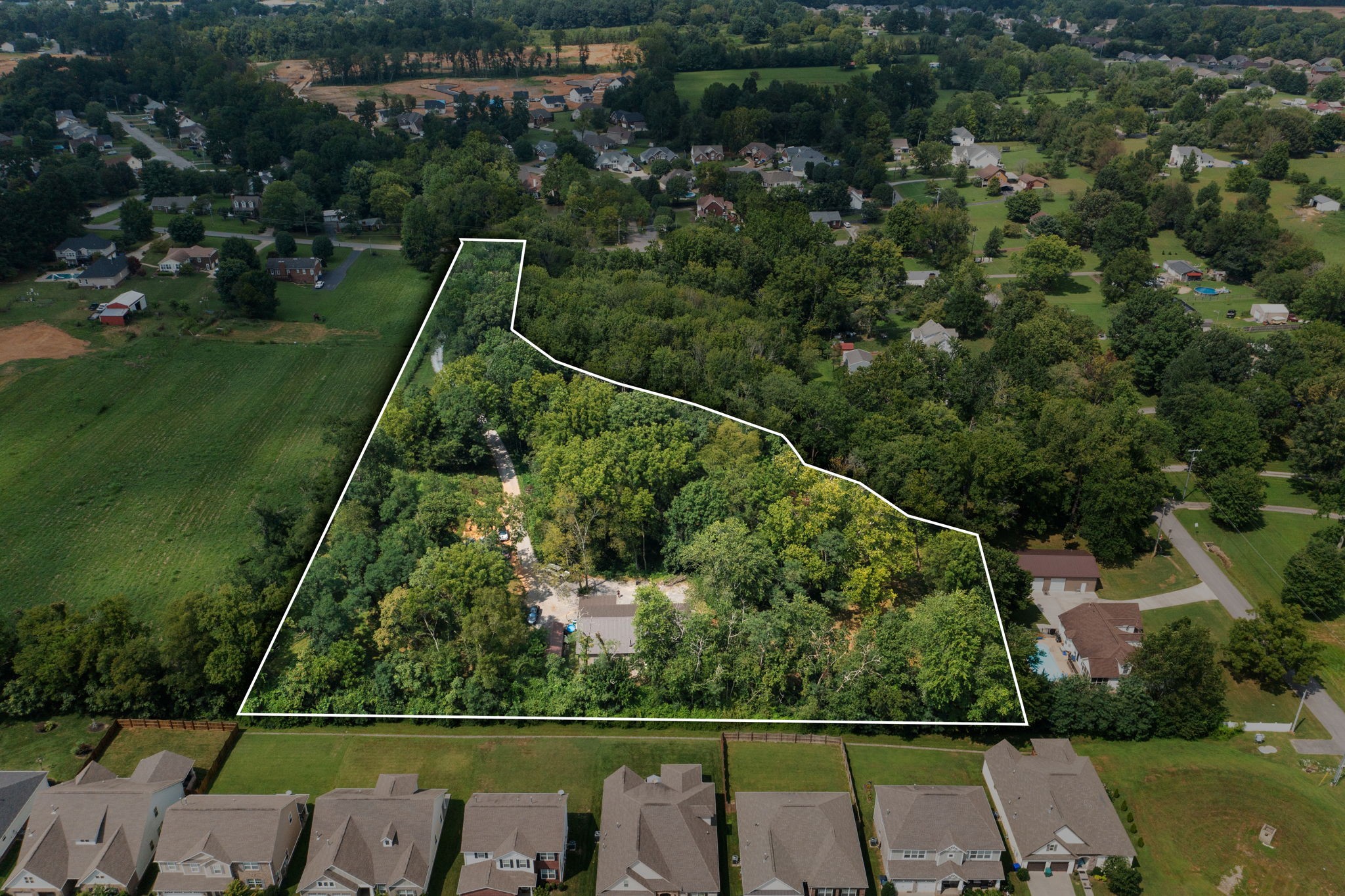 an aerial view of a houses with a yard