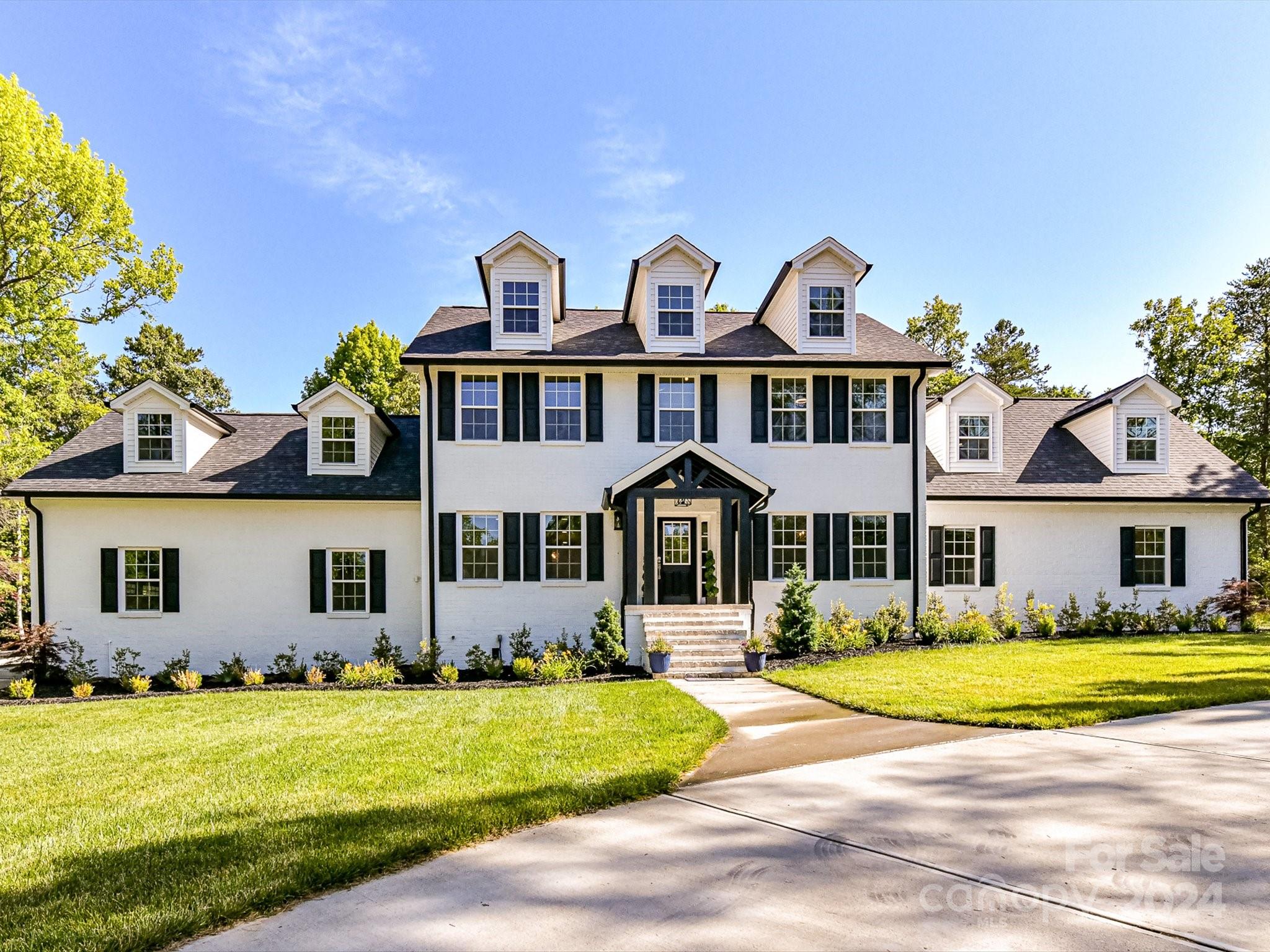 a front view of a house with a garden