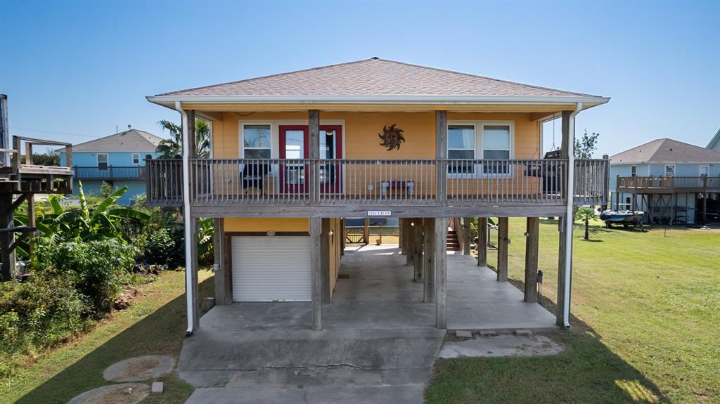 a front view of a house with swimming pool table and chairs