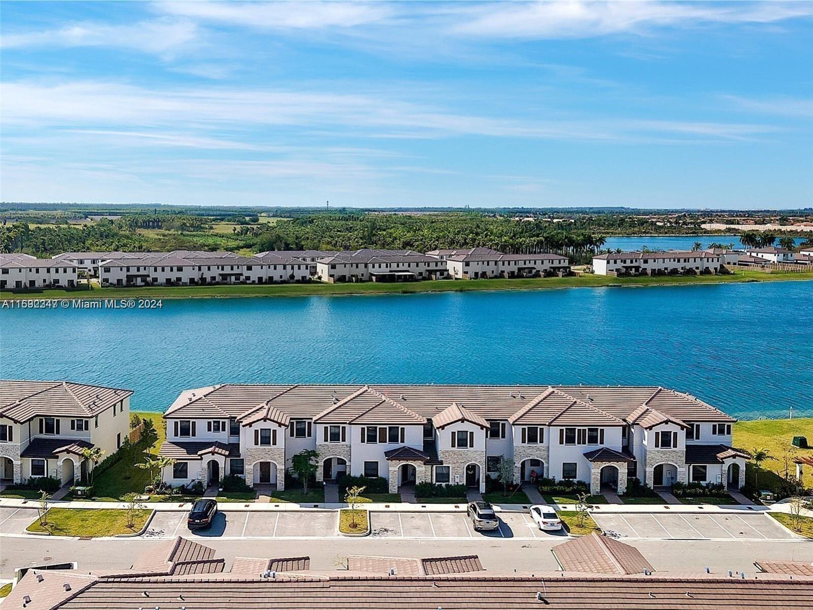 an aerial view of houses with a lake