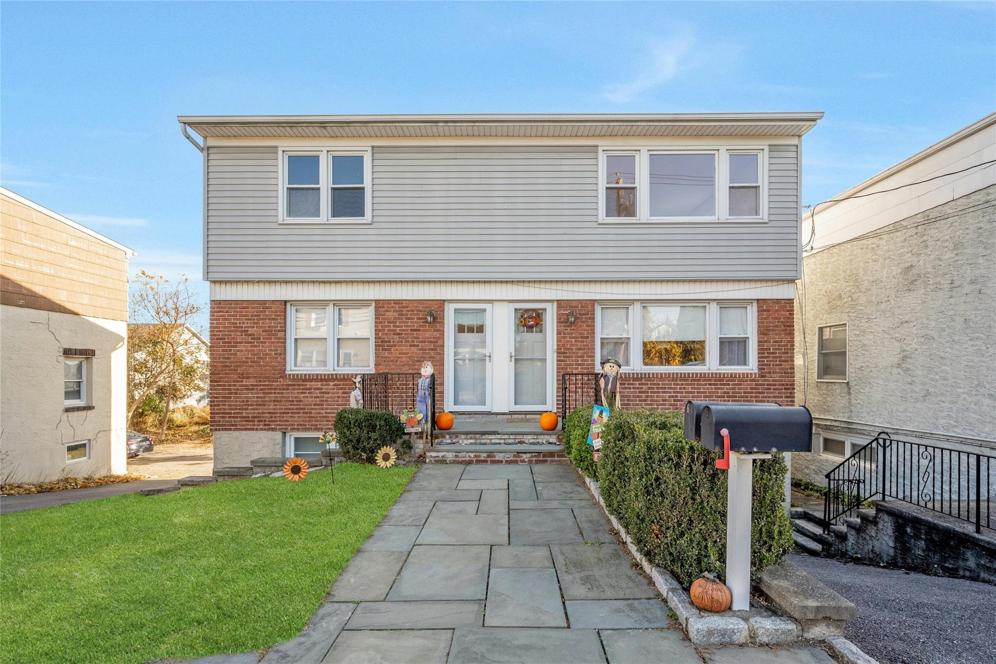 a front view of a house with a garden