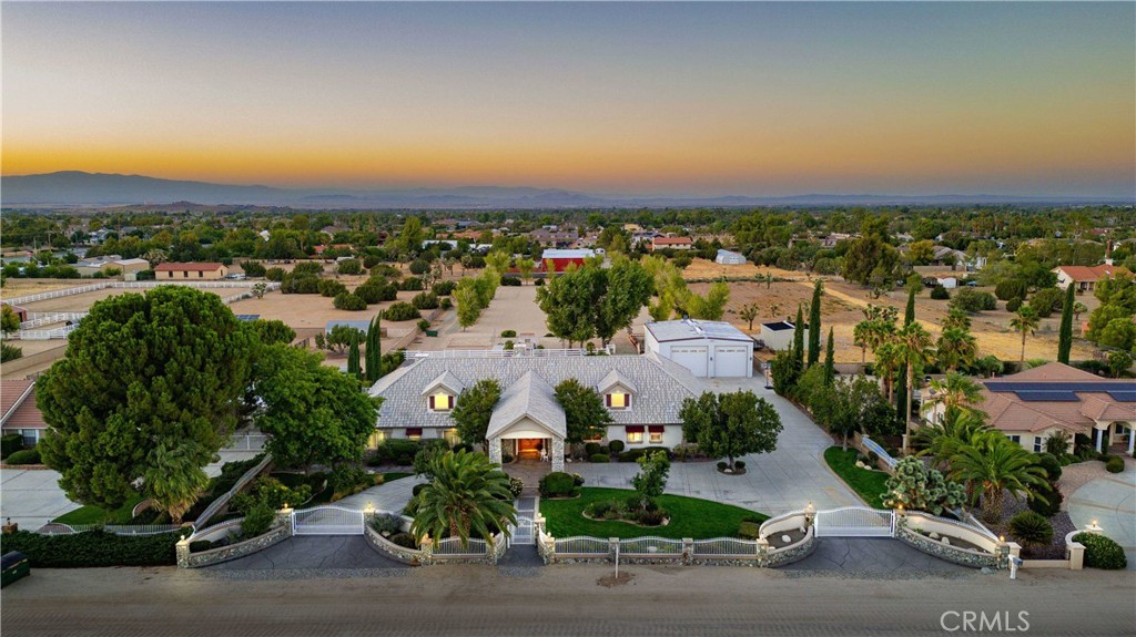 an aerial view of a houses with a yard and lake view