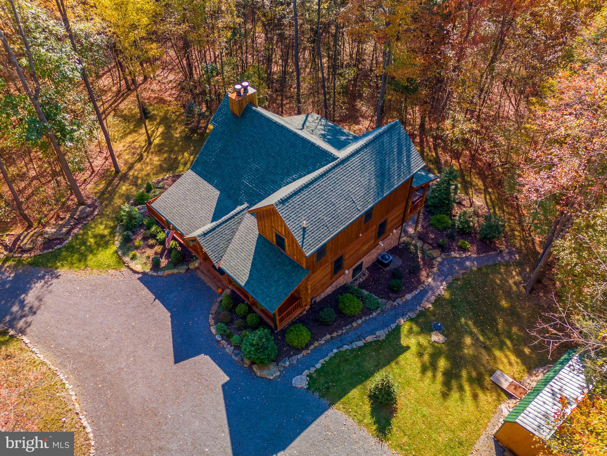 an aerial view of a house with swimming pool and a yard