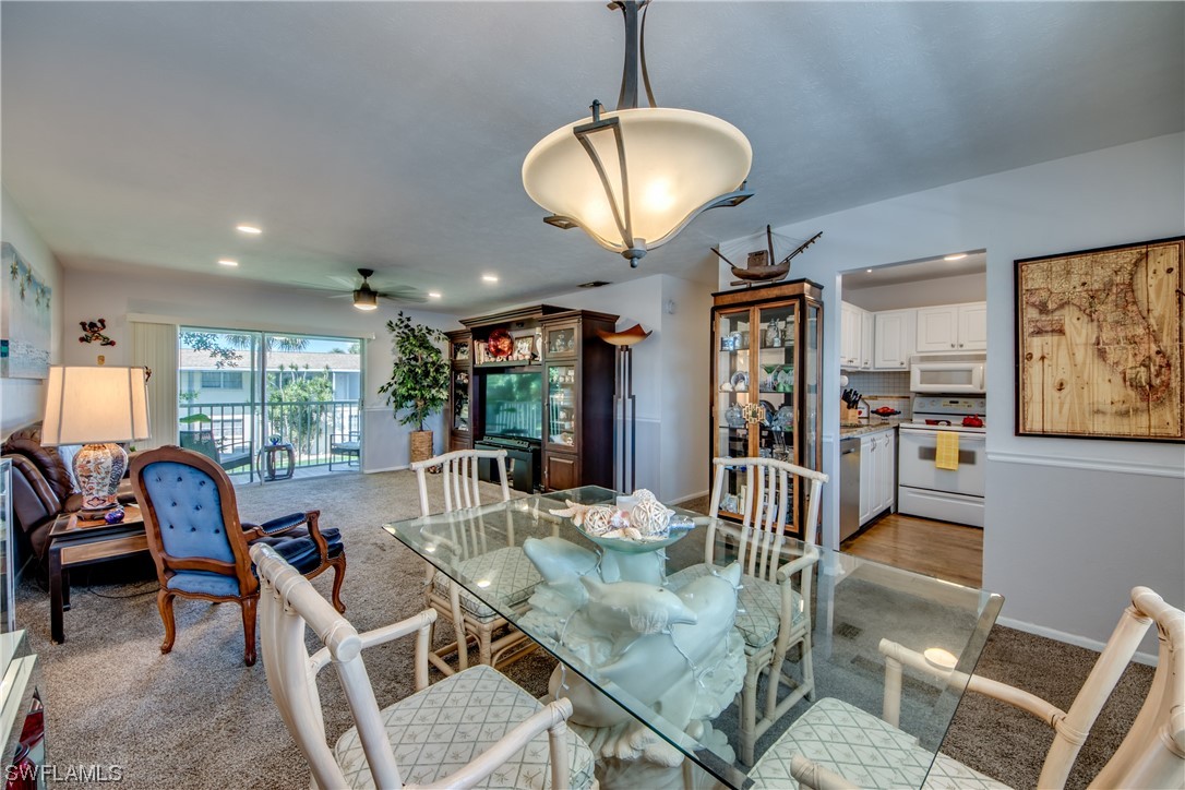 a view of a dining room with furniture wooden floor and chandelier