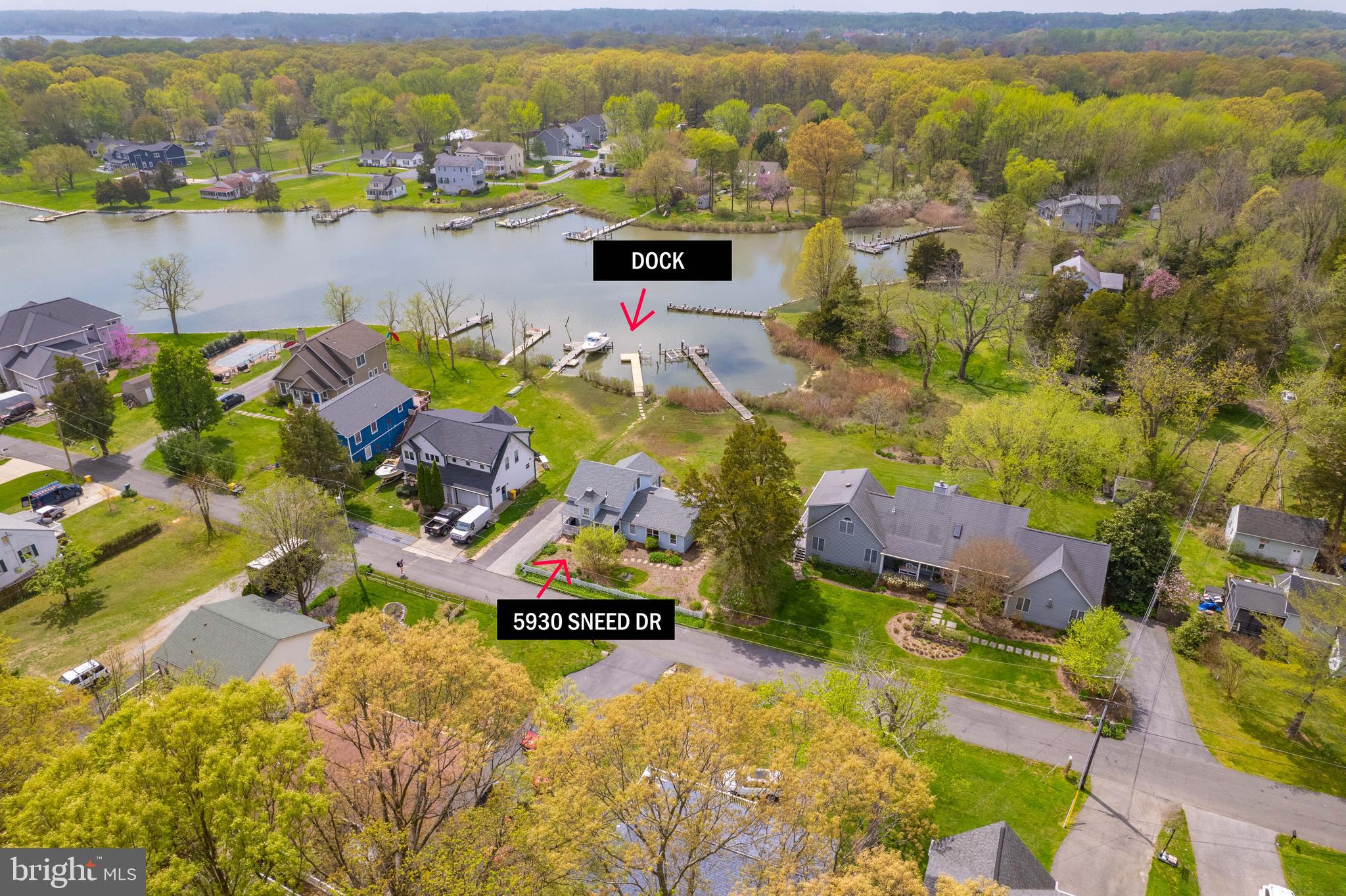 an aerial view of residential houses with outdoor space and swimming pool