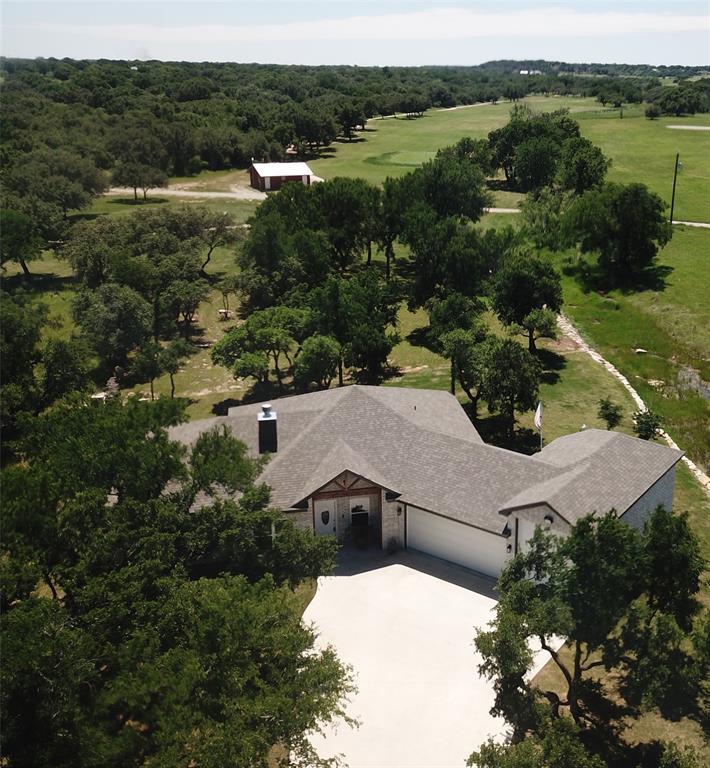 an aerial view of a house with a yard