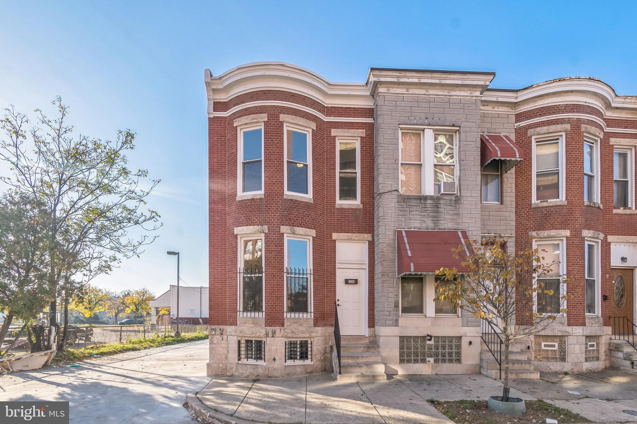 front view of a brick house with a large windows