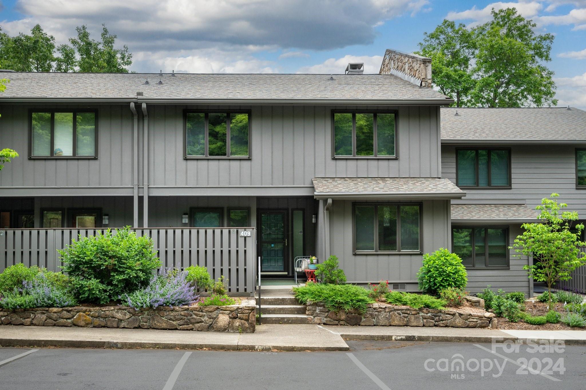 a front view of a house with a garden