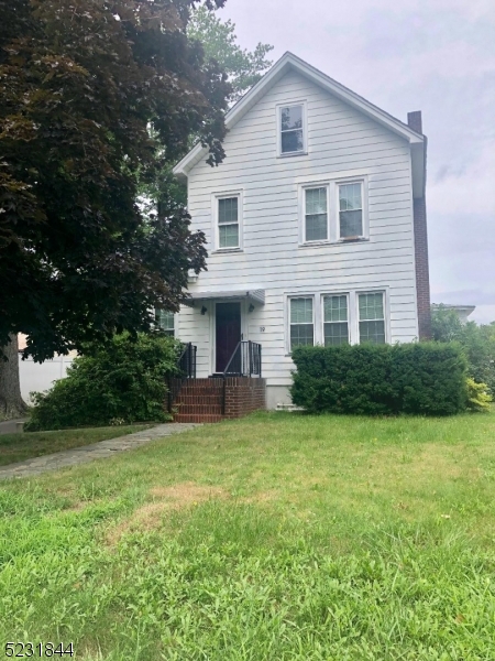 a view of a house with a yard and a garden