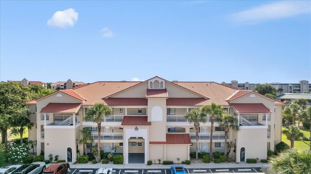 a front view of a residential apartment building with a yard