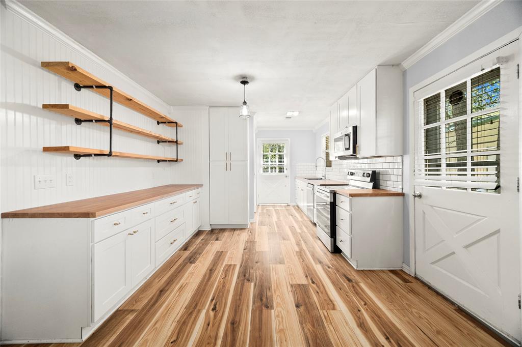 a kitchen with cabinets a sink and wooden floor