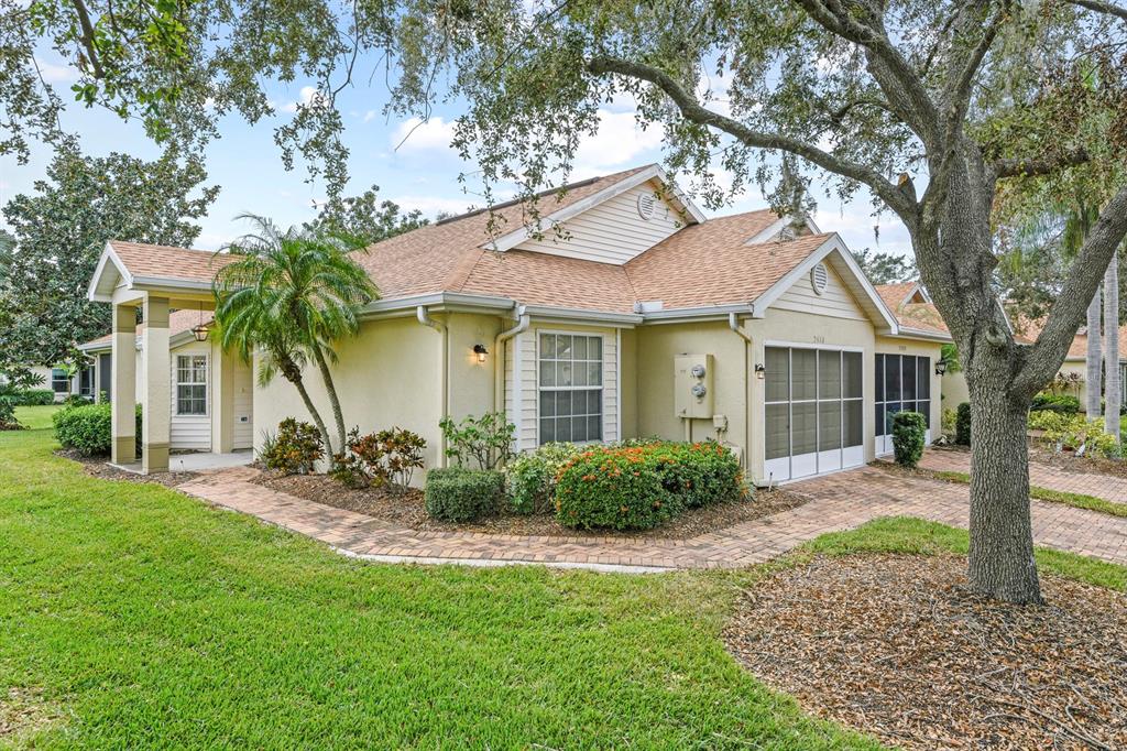 a front view of a house with a garden and yard