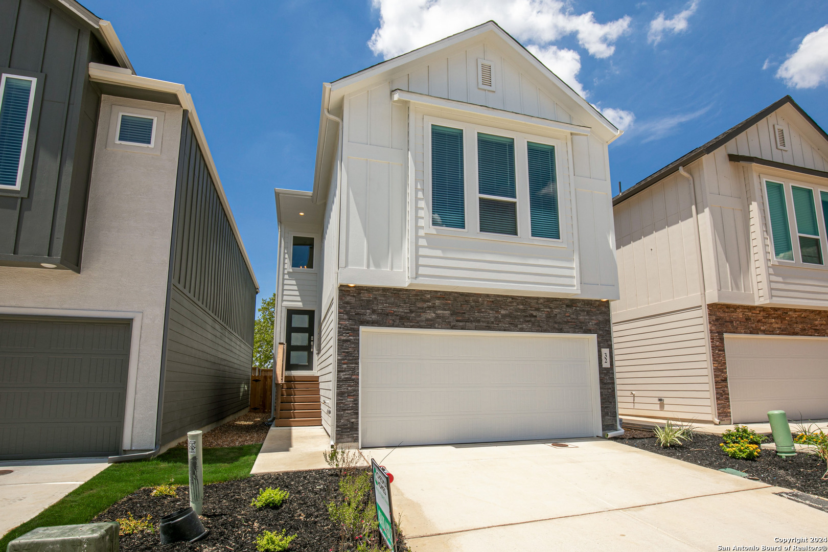 a front view of a house with garage