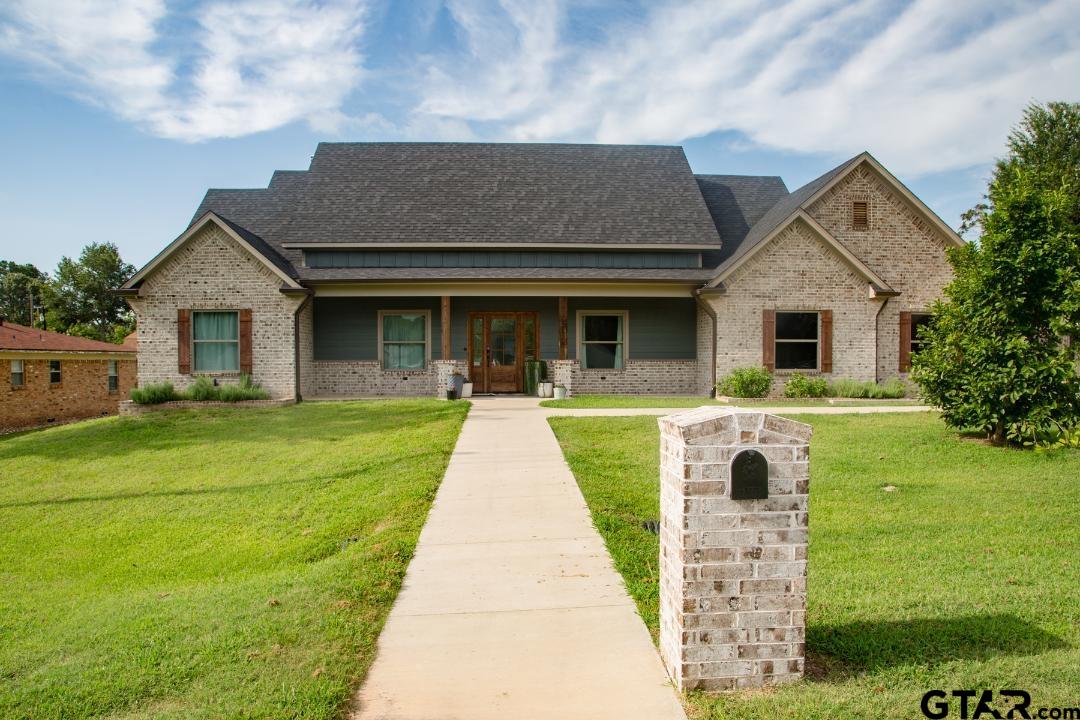 a front view of house with yard and green space