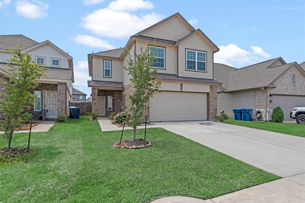 a front view of a house with a yard and garage