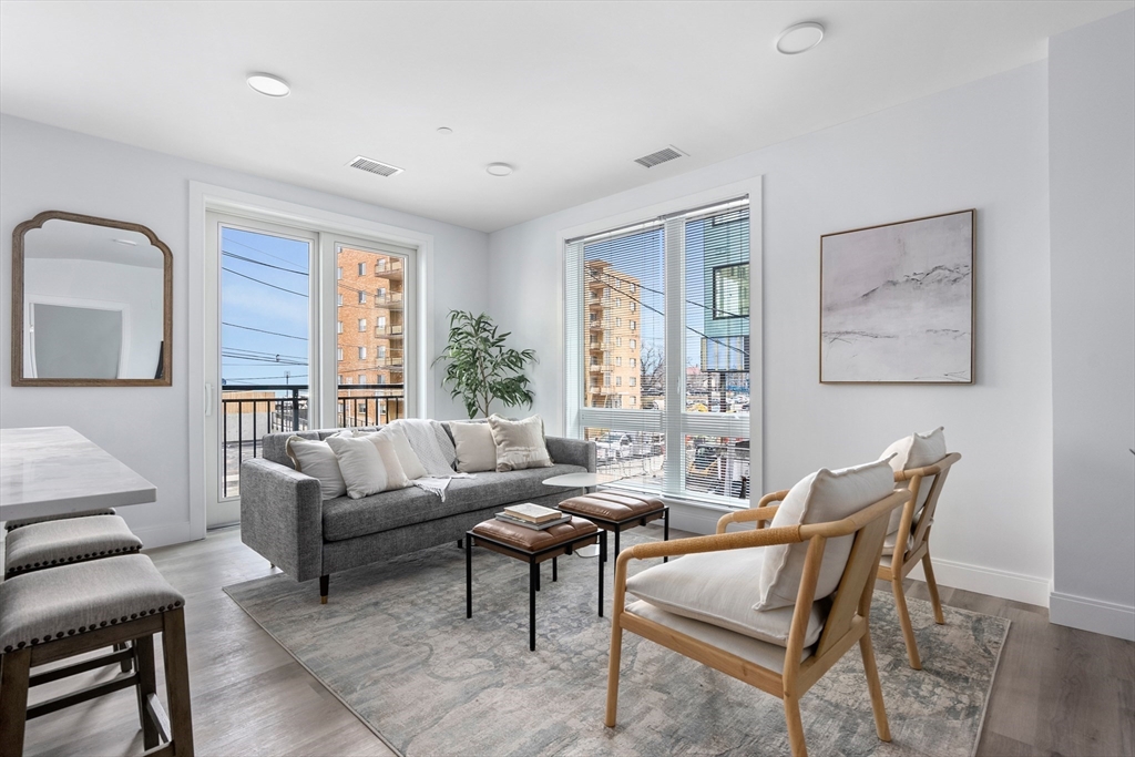 a living room with furniture and a large window