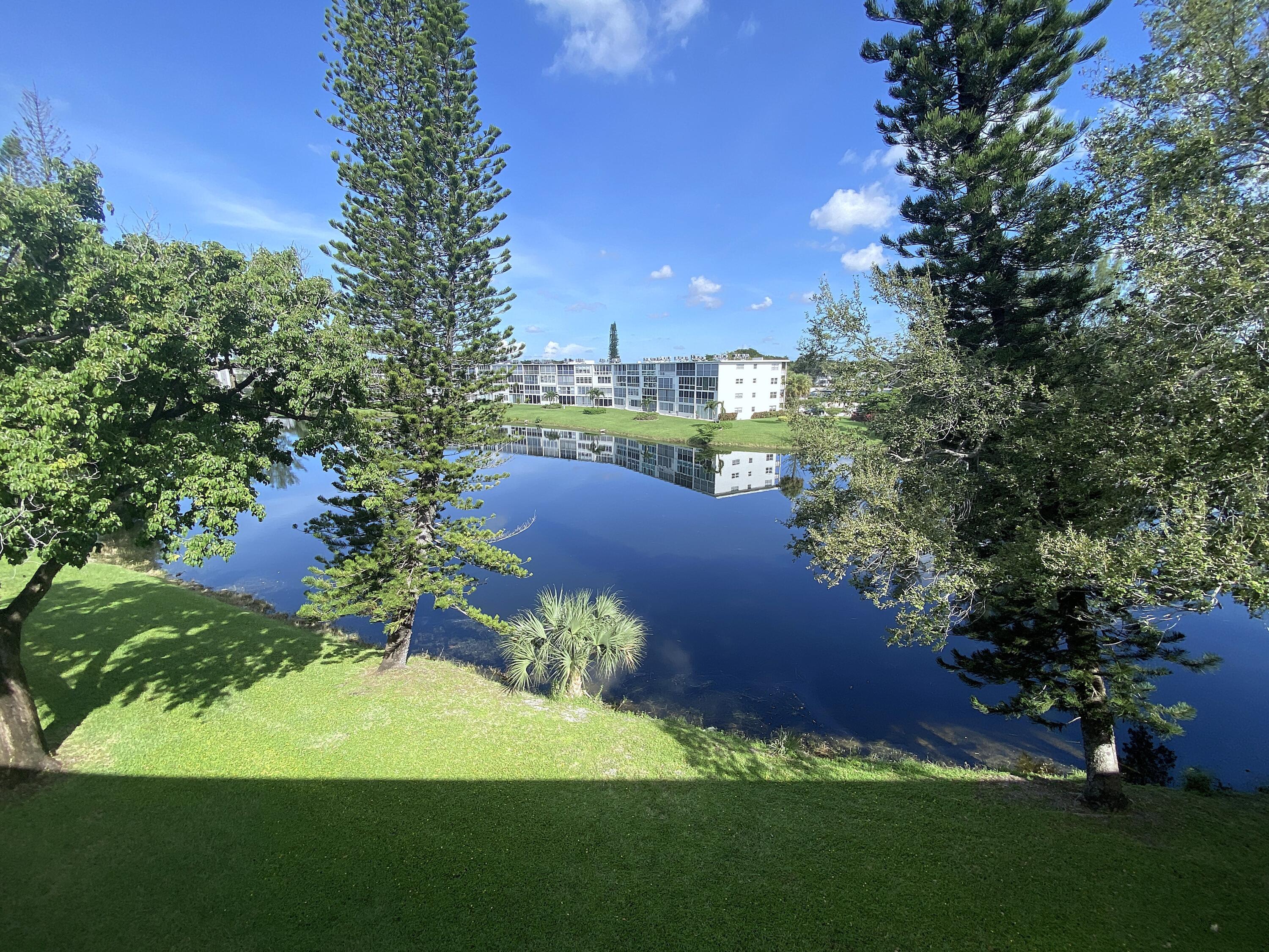 a view of a garden with a building in the background