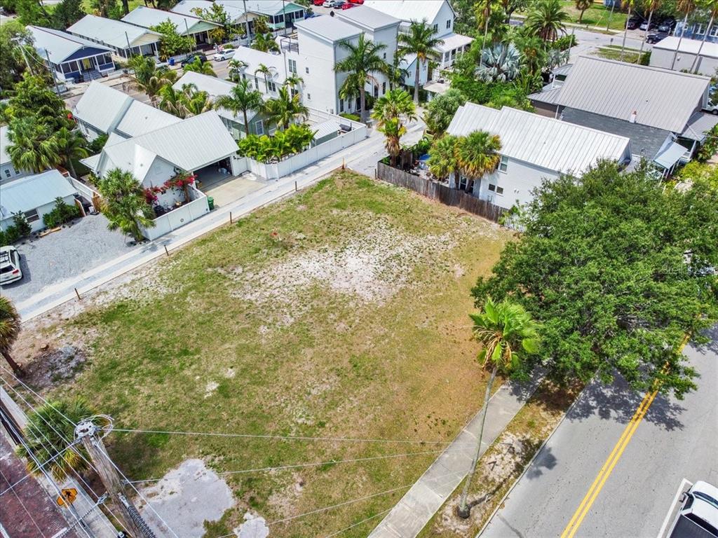 an aerial view of a residential houses with yard