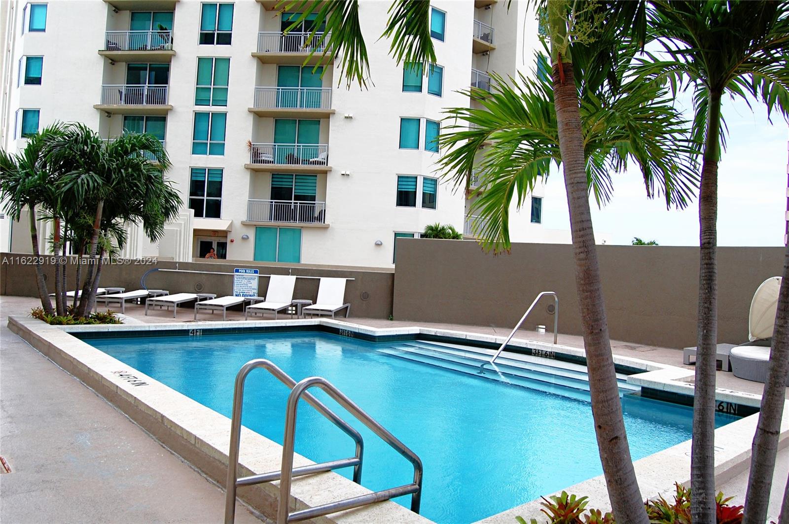 a view of a swimming pool with a table and chairs