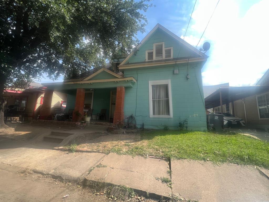 a view of a house with a patio and a yard