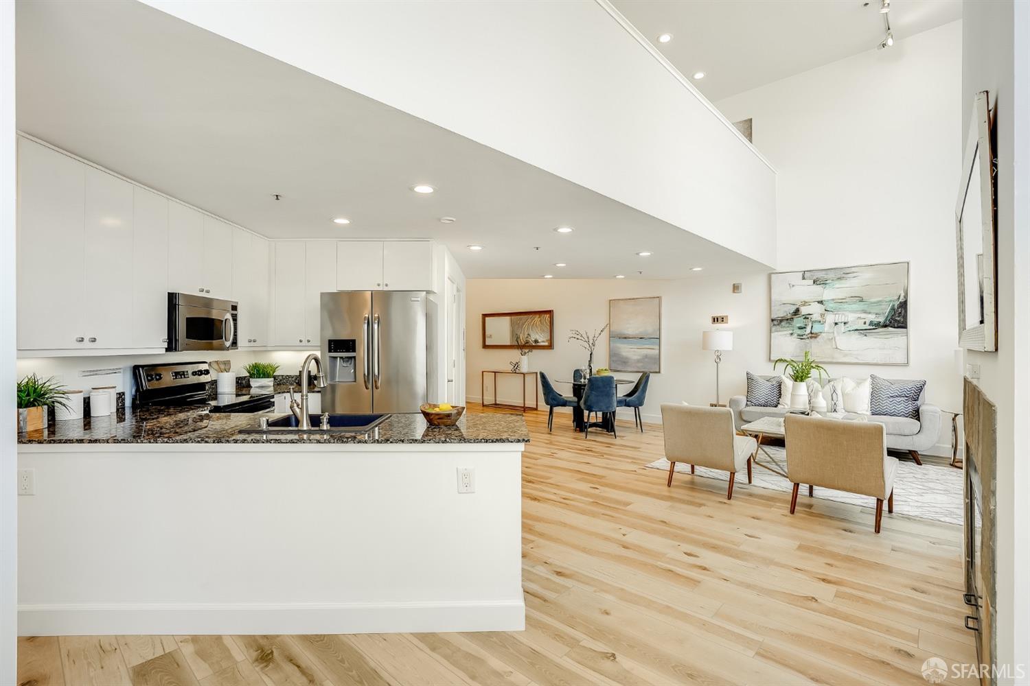 a living room with stainless steel appliances kitchen island granite countertop a living room view and living room view