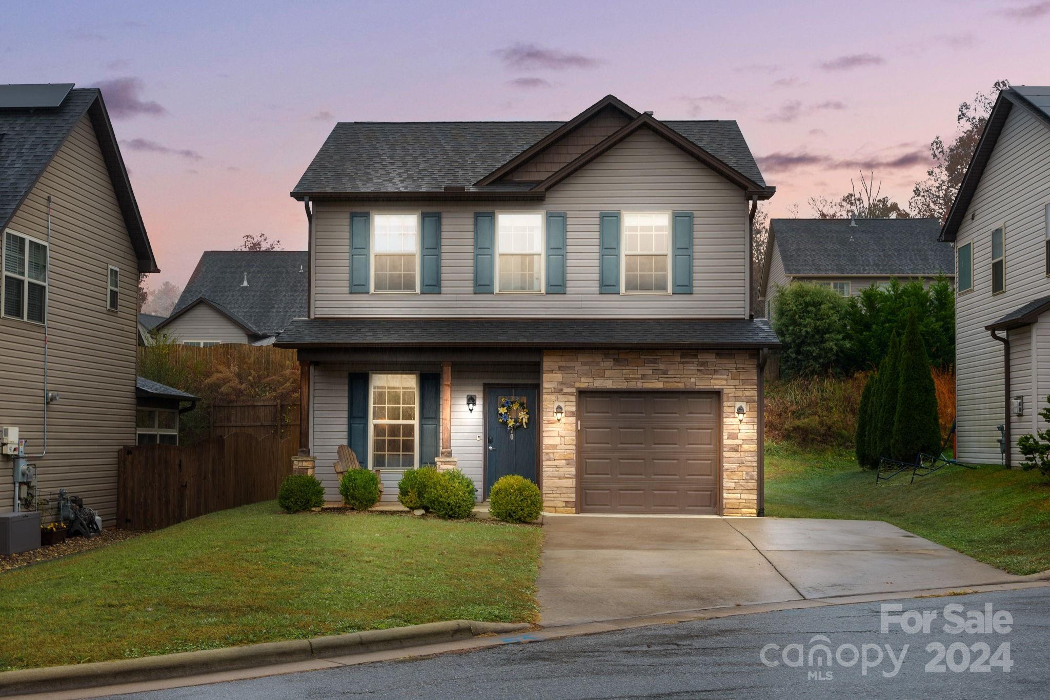 a front view of a house with a yard and garage