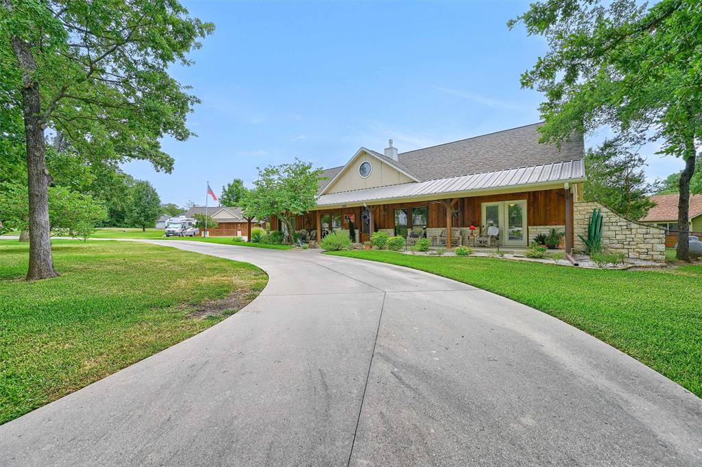 a view of house with yard and green space