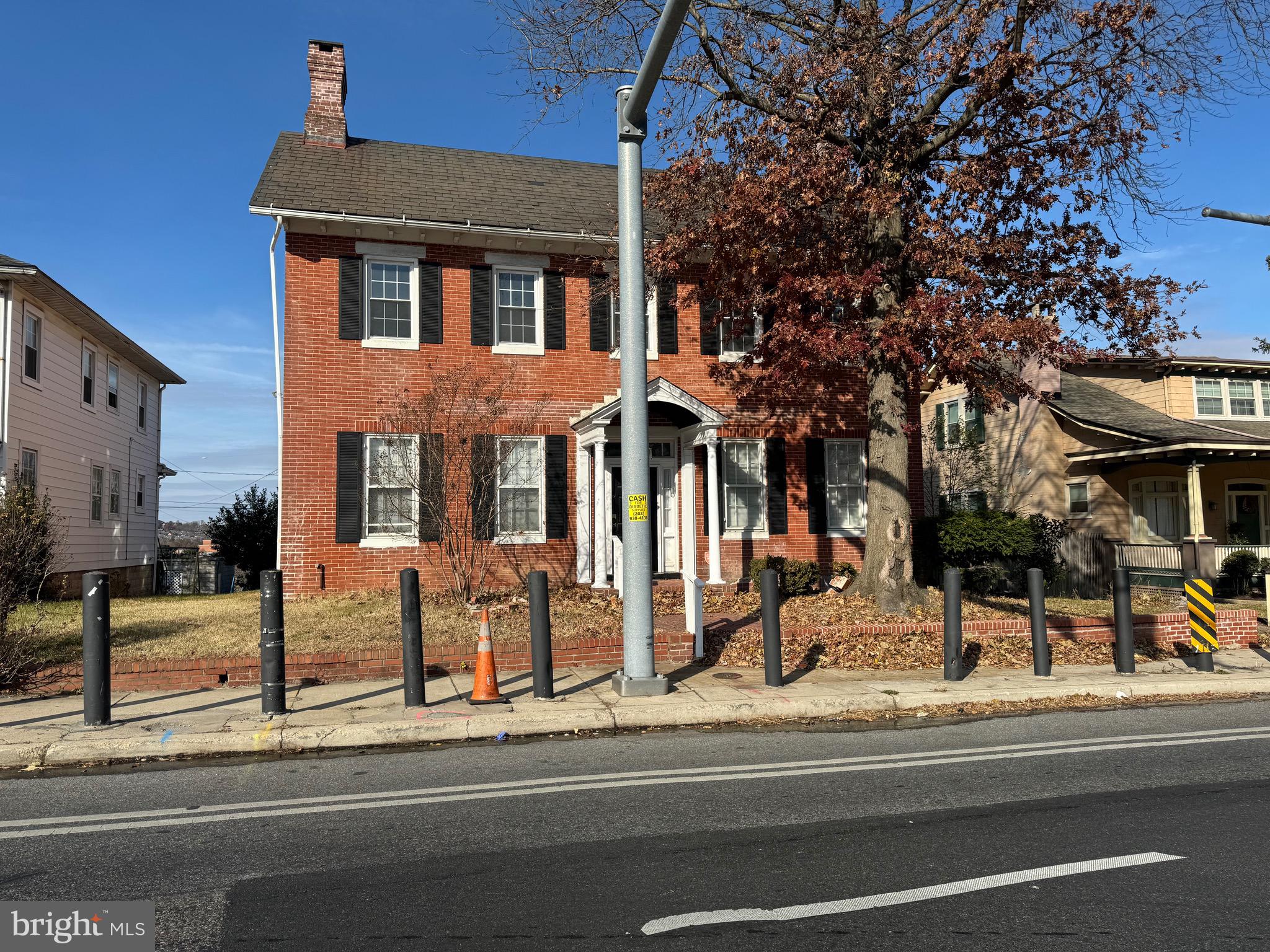 a view of a brick building next to a road