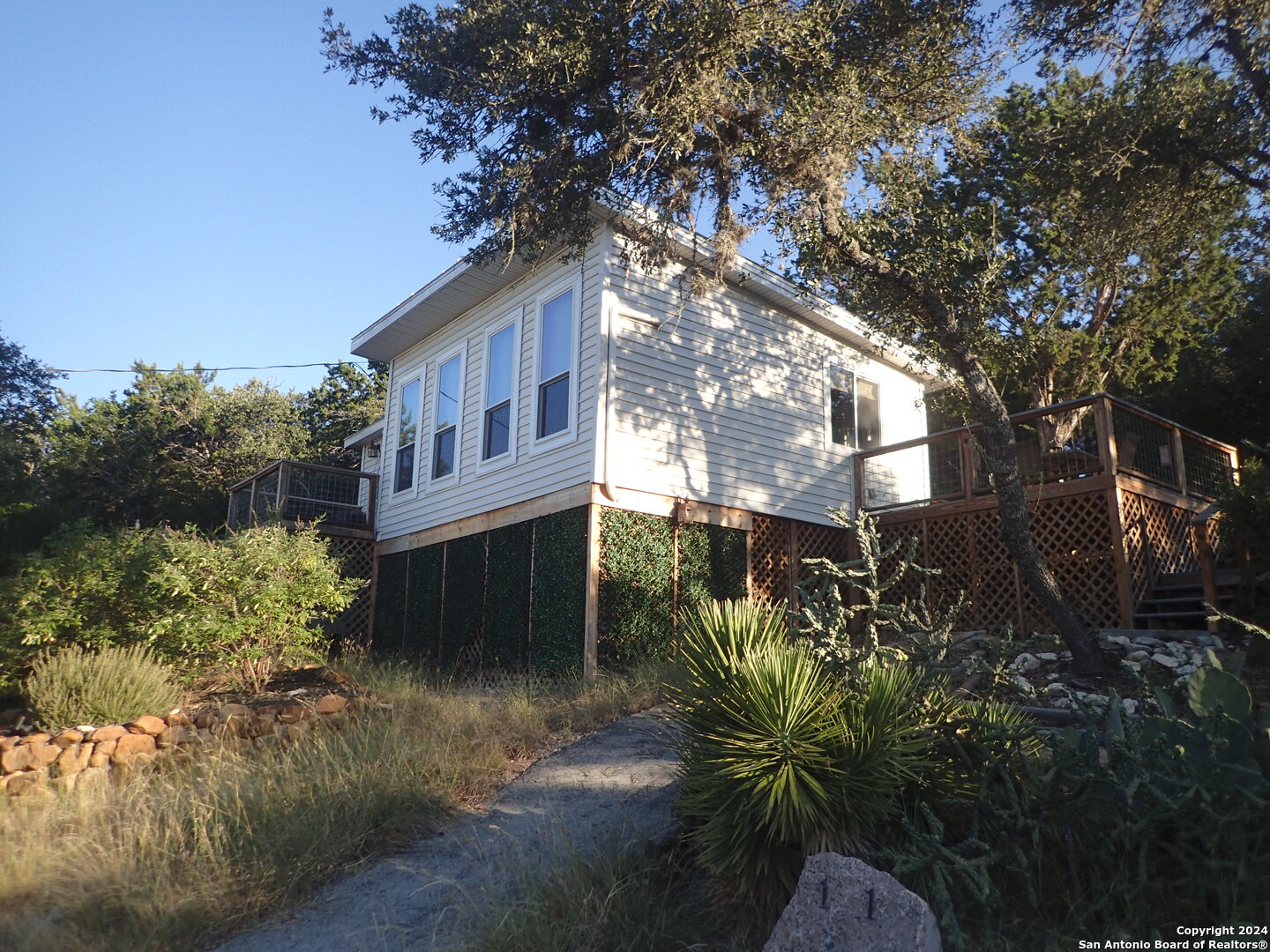 a view of a house with a tree in the yard